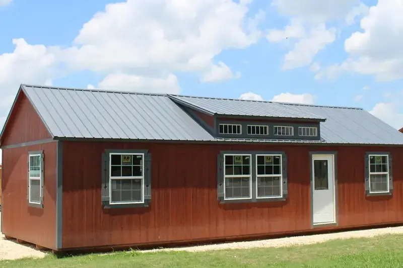 16x40 Dormer Cabin Shell, full side under a cloudy sky