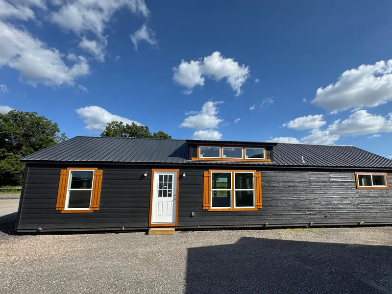 18x54 Tiny Home – Model 8530, front exterior under a cloudy sky