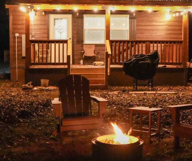 14x24 Tiny Home &ndash; Model 8701, covered porch at night