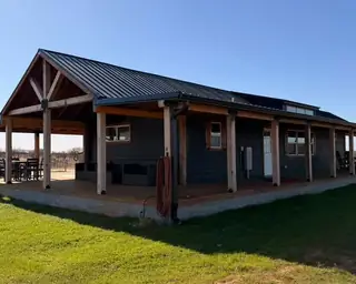 18x48 Tiny Home &ndash; Model 8068, shown with optional wraparound porch